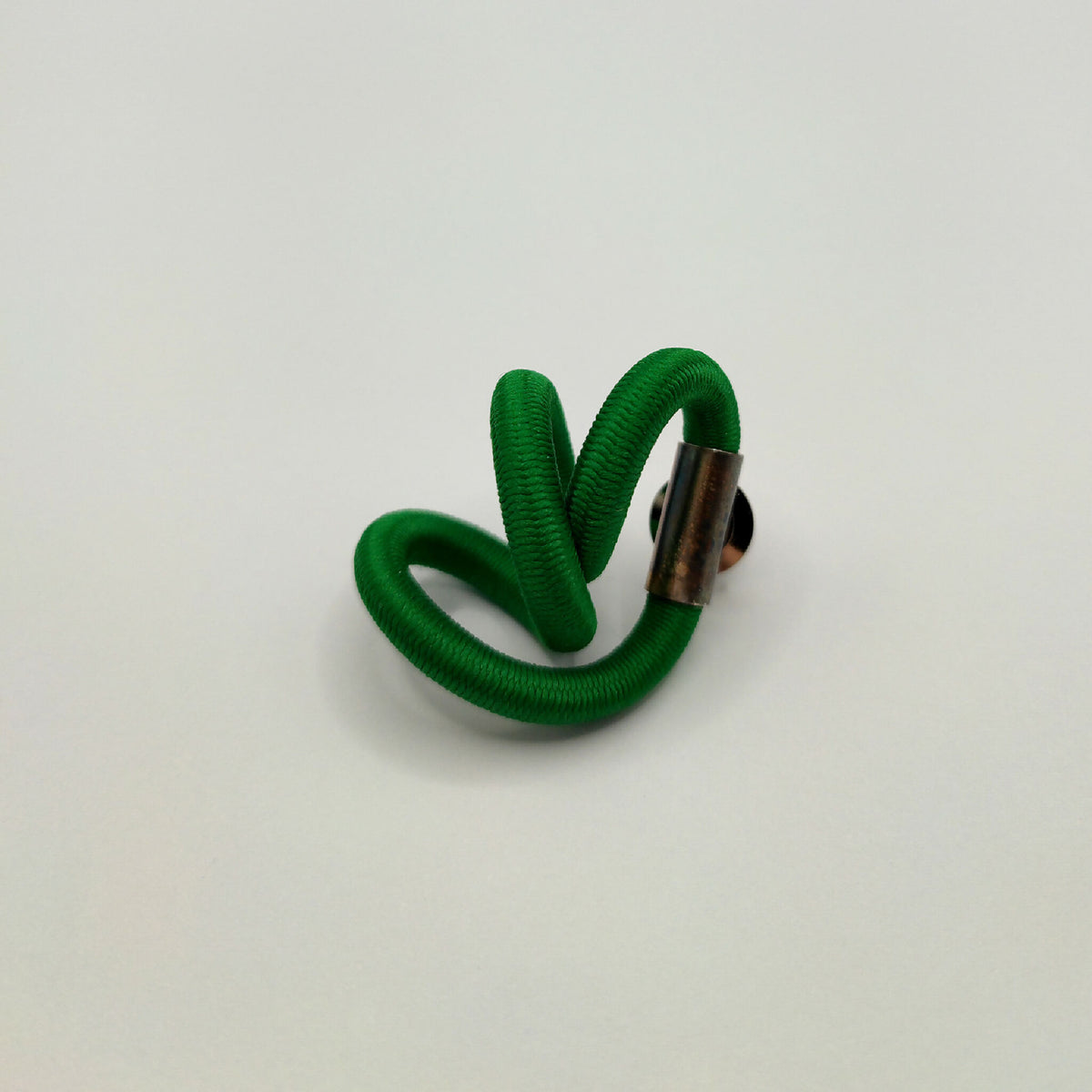 Broche torsadée vert foncé avec fermoir argenté sur le côté
