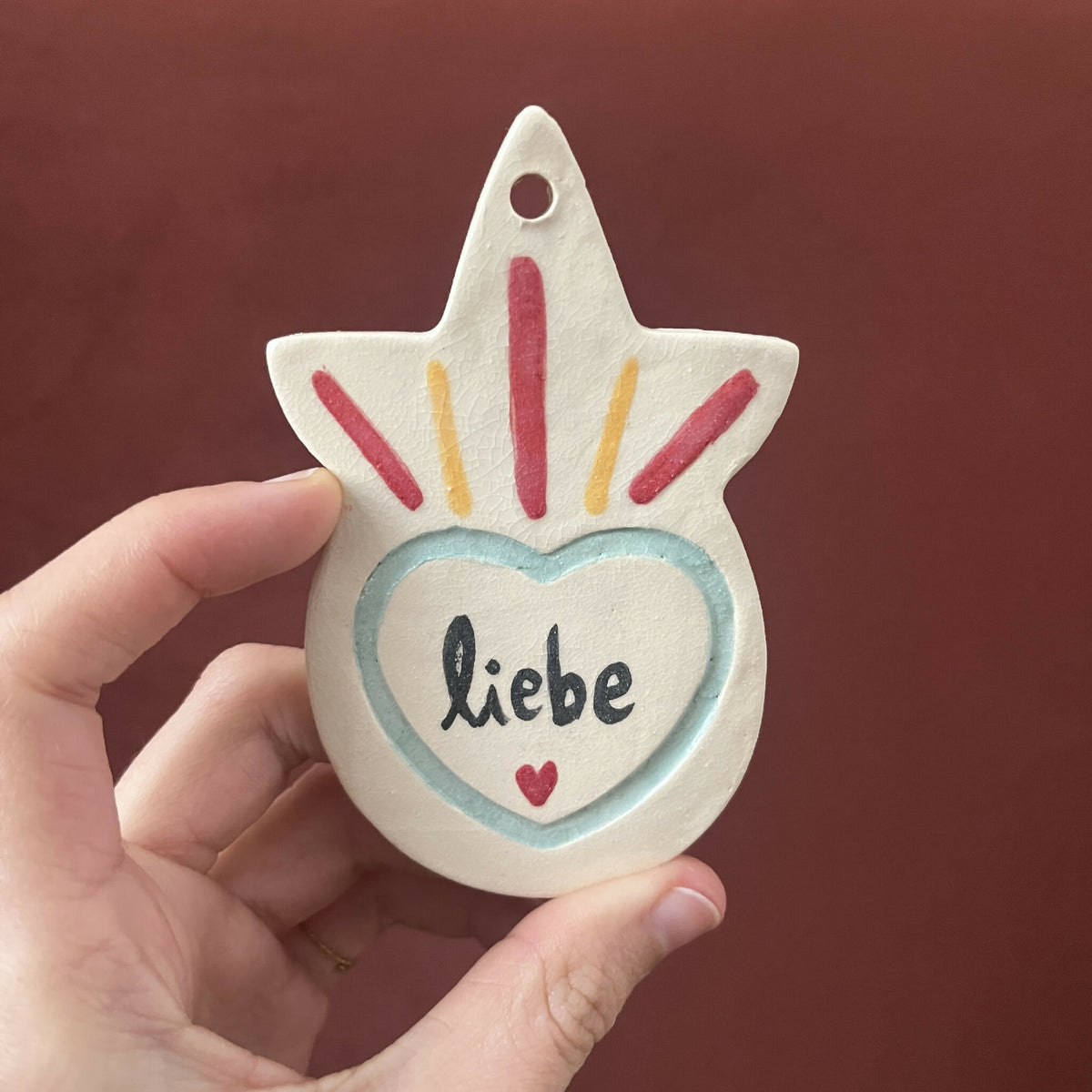 Ex-voto étoile peint, cœur « Liebe » bleu-vert, petites étincelles multicolores.