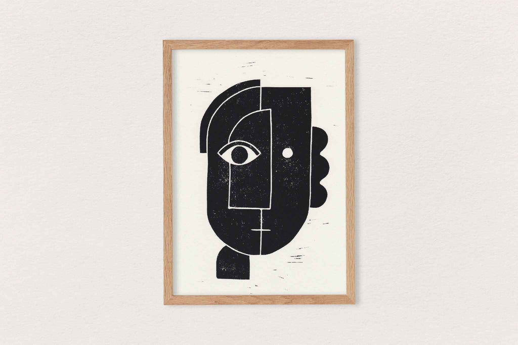 Linogravure encadrée, visage abstrait noir sur fond clair, composition géométrique