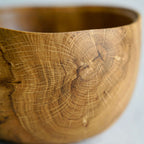 Bol en bois fait main tannée, extérieur aux veines claires et nœuds près du rebord.