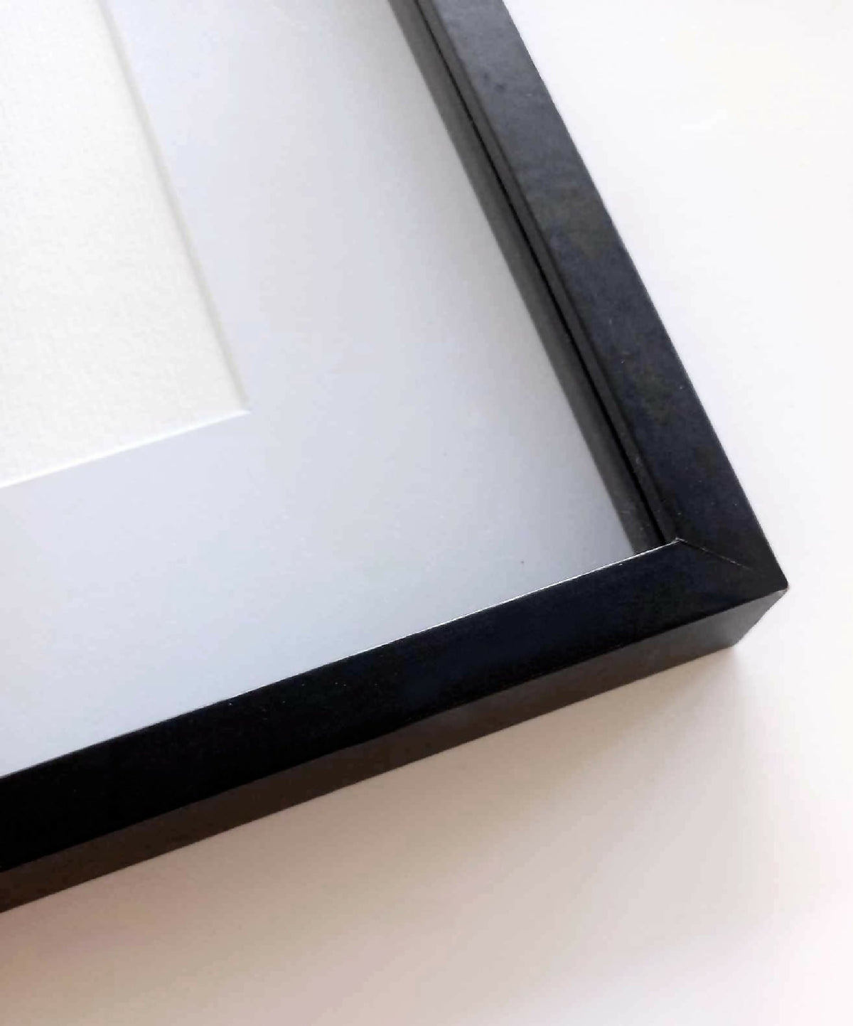 Cadre noir d’affiche avec passe-partout blanc, vue d’angle.