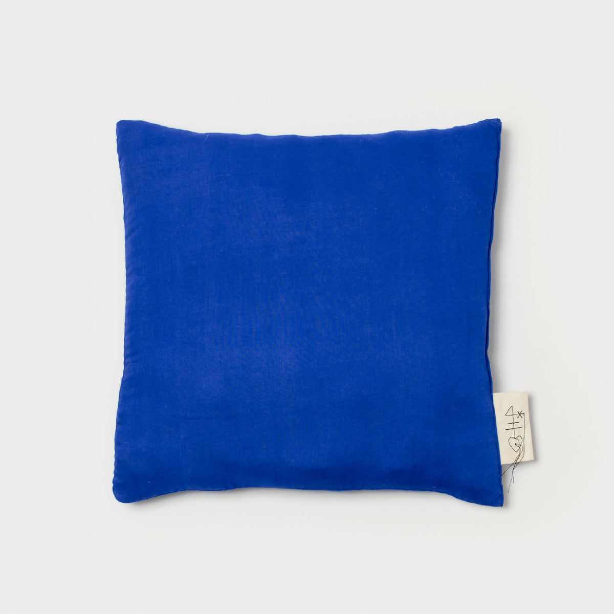 Coussin bleu rectangulaire, étiquette sur le côté droit, vue de face