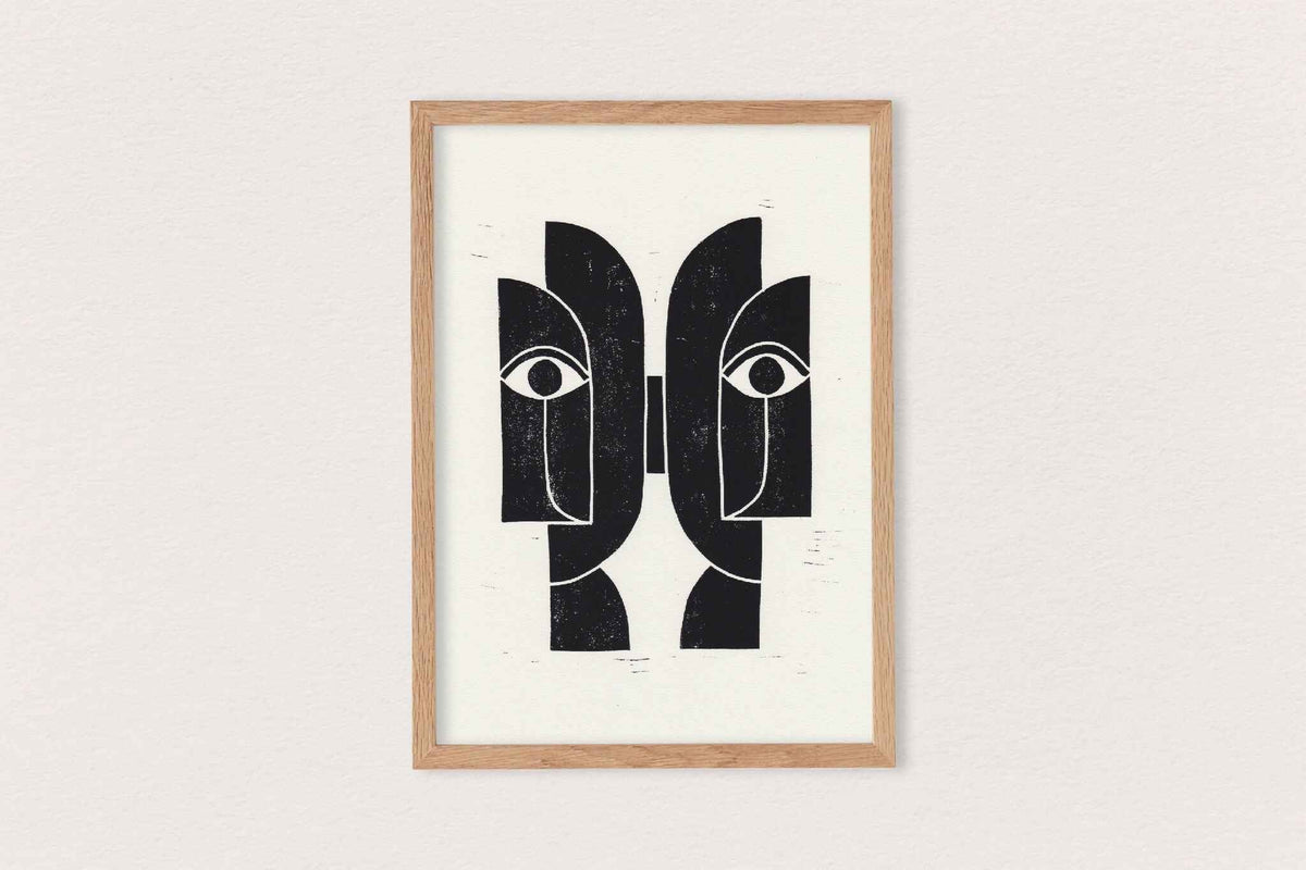 Linogravure encadrée « Sœurs Jumelles » : visages abstraits noir sur fond clair