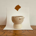 Tasse Bulle en céramique beige, forme arrondie et anse courbe.
