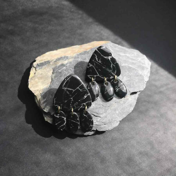 Boucles d’oreilles pendantes en gouttes noires marbrées, finitions dorées visibles