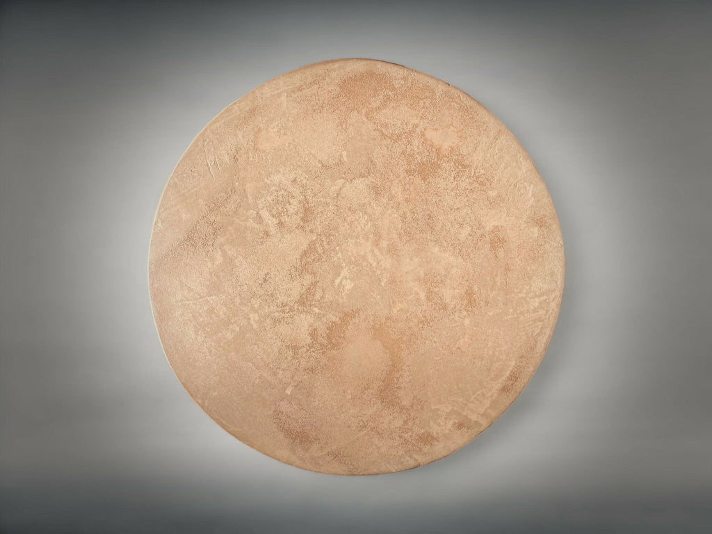 Bout de canapé rond : vue de dessus en tissu beige, surface texturée.