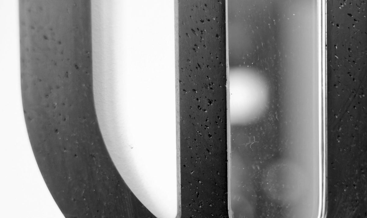 Détail d’une décoration murale ovale noire avec surface texturée