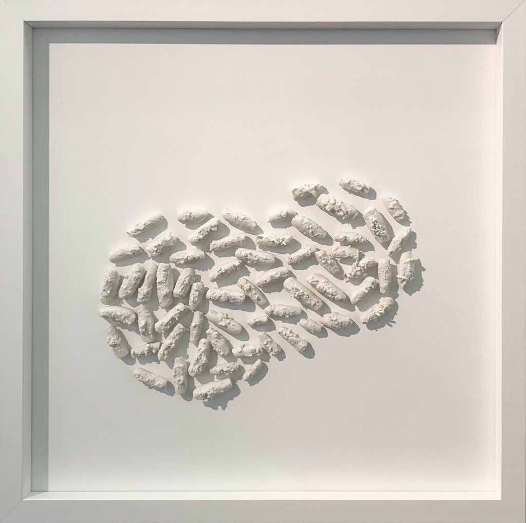 Tableau encadré en relief avec motif ondulé en éléments blancs, vue rapprochée