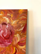 Gros plan sur tableau décoratif abstrait : tourbillon rose et touches orange, effet matière.
