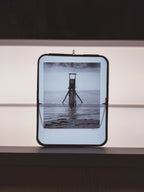 Cadre photo carré avec photo de la mer et plateforme, bord noir, accroche murale