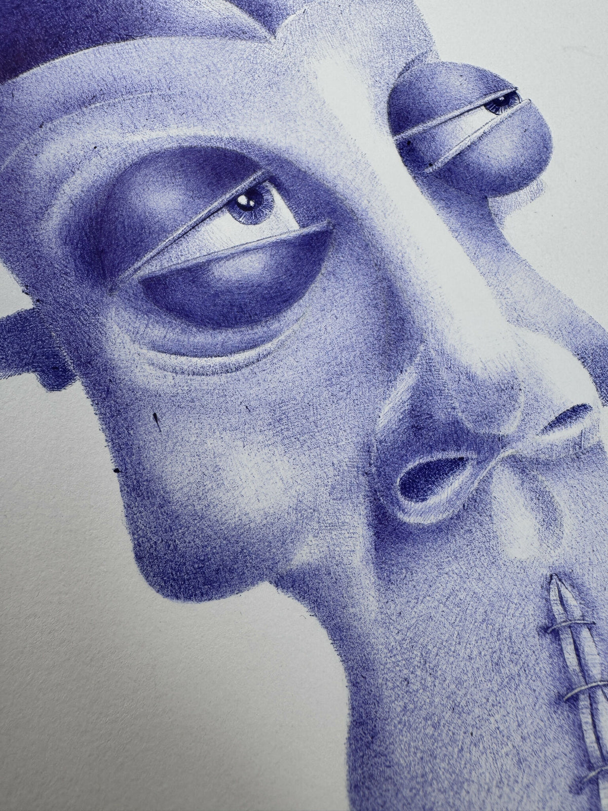 Masque décoratif stylisé, gros plan sur le visage bleu-violet, œil et bouche