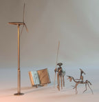 Sculpture en acier complète : mât, hélice, livre ouvert et personnages sur socle.