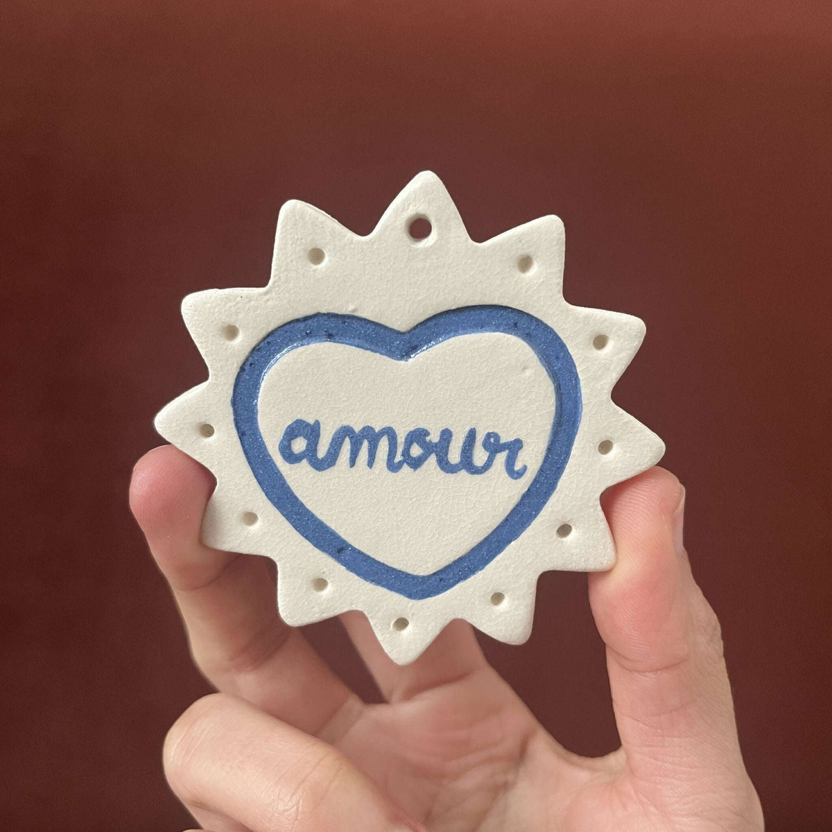Ex-voto monochrome en étoile, cœur bleu avec le mot « Amor »