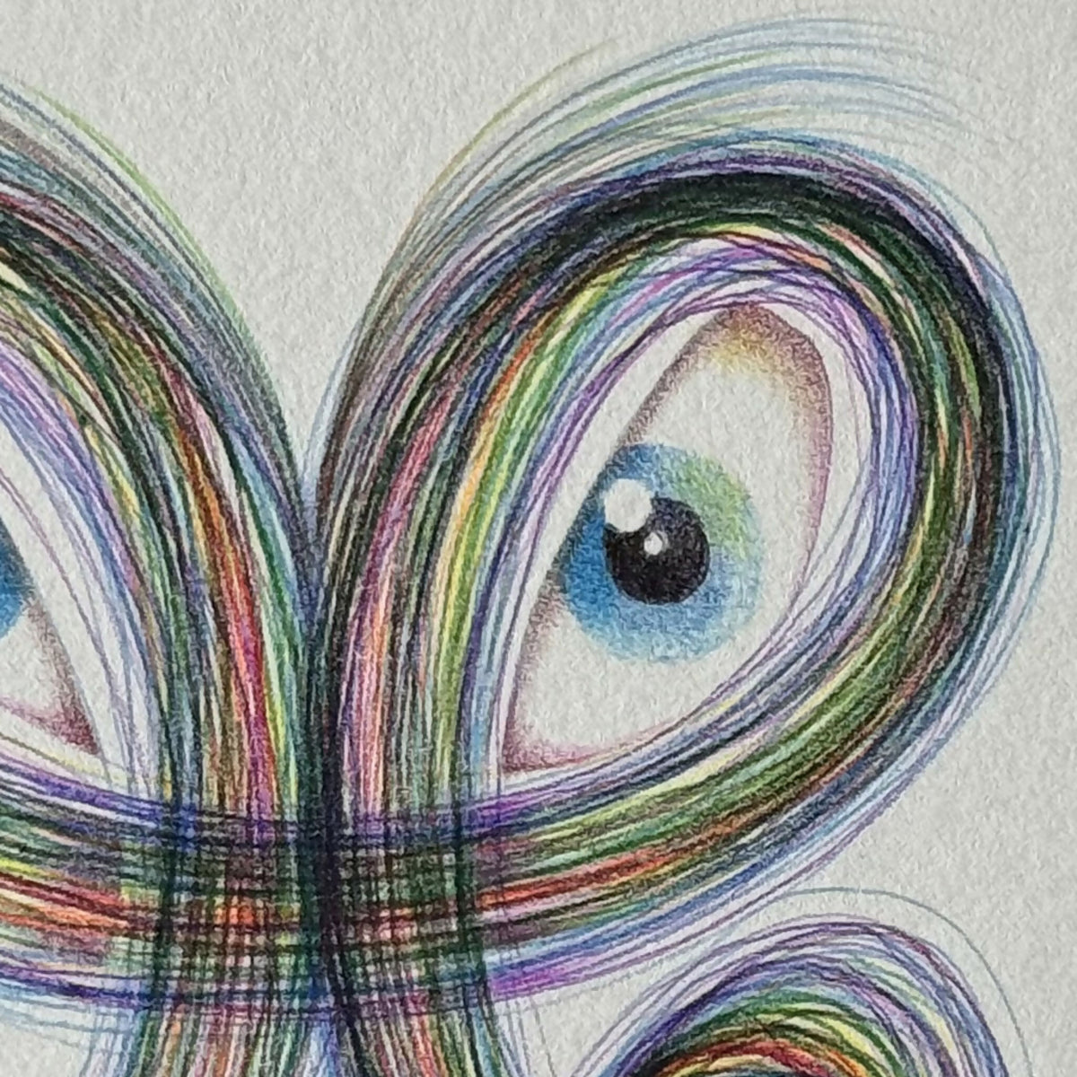 Motif de dragon en fil multicolore, gros œil bleu et boucles colorées