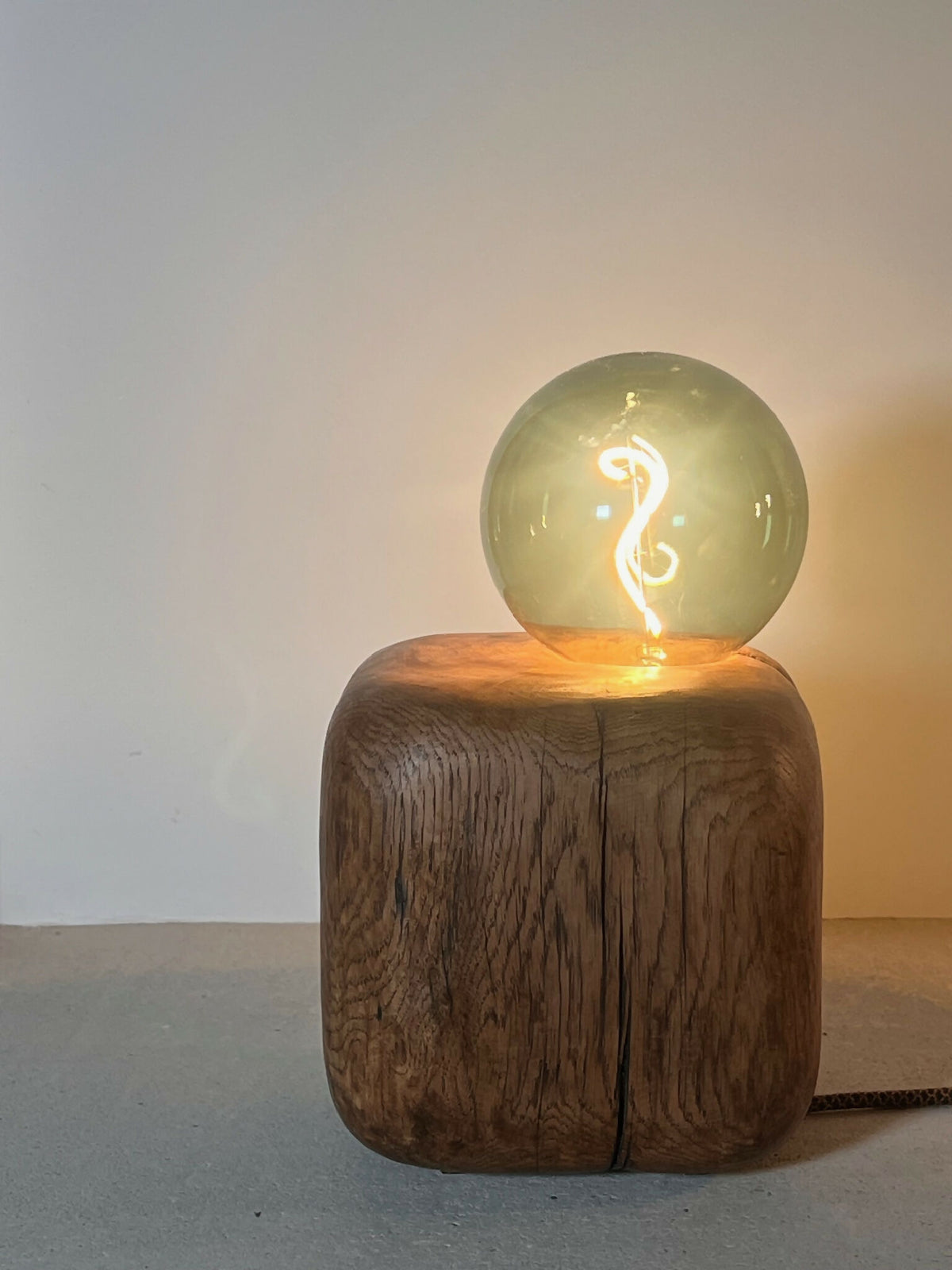 Sculpture lumineuse CUBE SPHERE : globe en verre vert sur bloc brun en bois