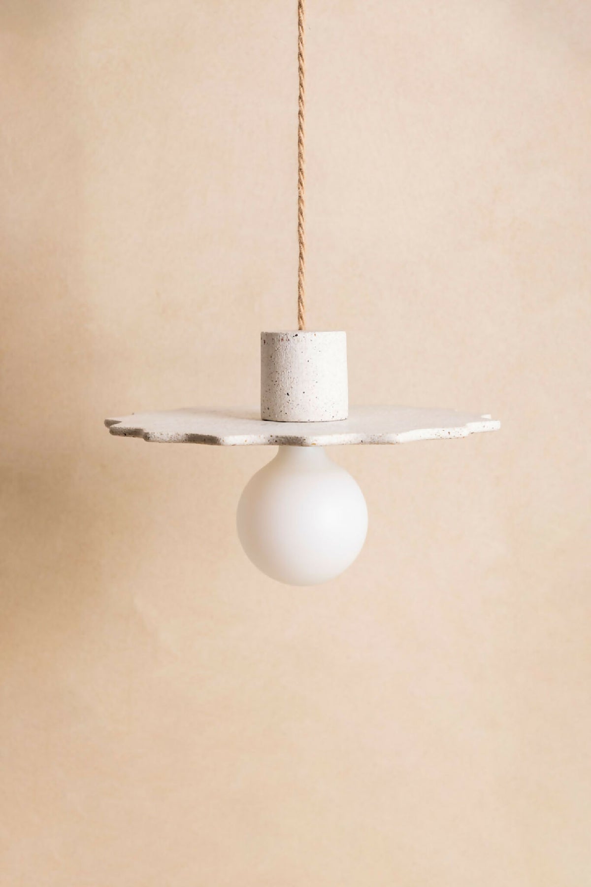 Suspension au diffuseur sphérique blanc, plateau irrégulier en finition sable.