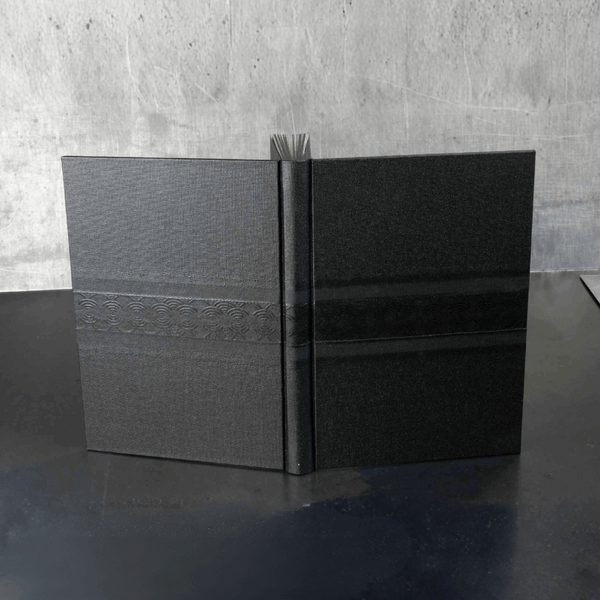 Carnet ou livre d'or noir en toile, couverture ouverte avec élastique au centre