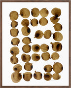 Composition de taches au café brunes sur papier coton, dans un cadre en bois.