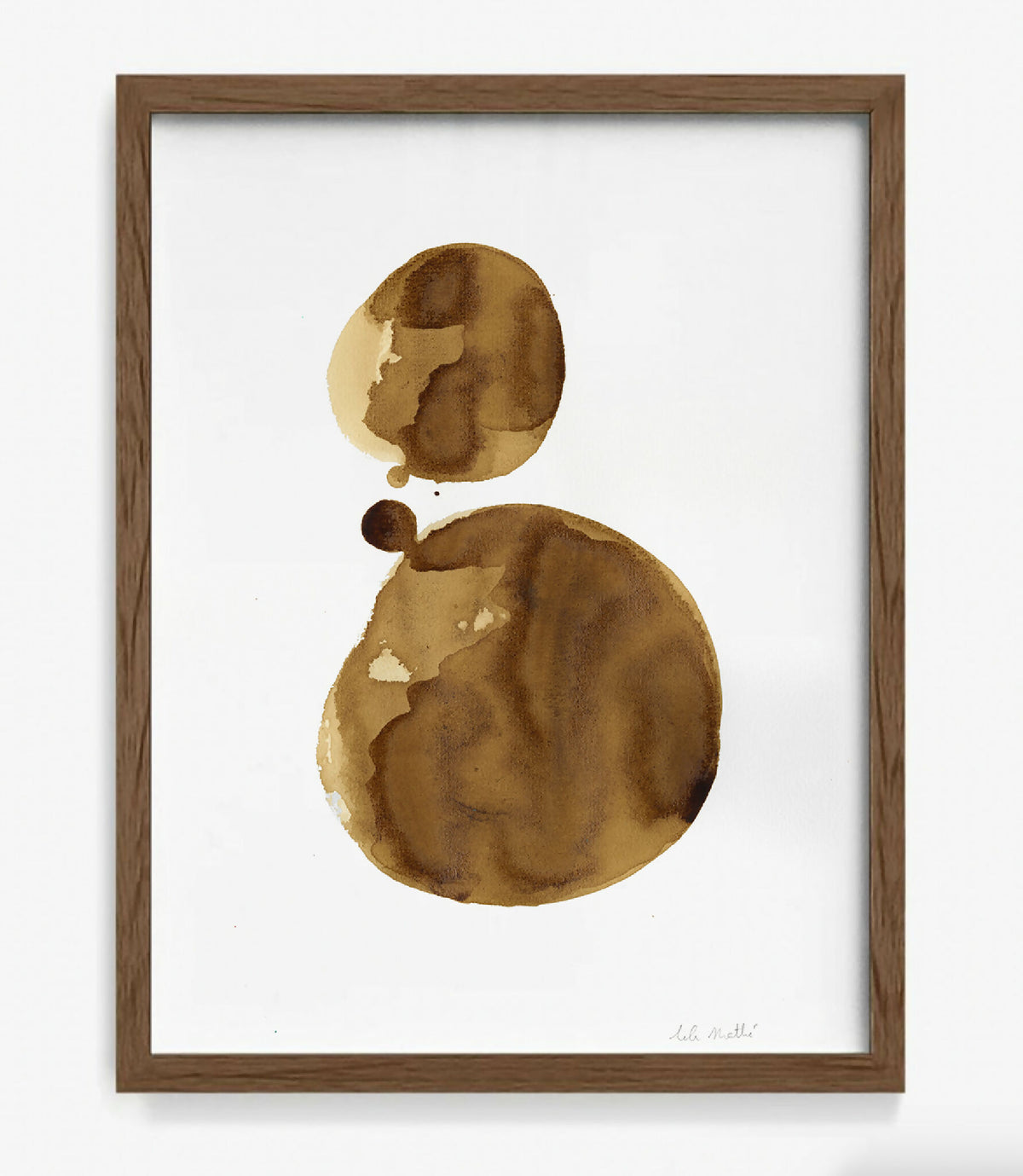 Tableau encadré avec peinture café sur papier coton, forme ovale et points bruns.