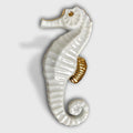 Porte-couverts hippocampe en porcelaine blanche, détails dorés, une pièce.