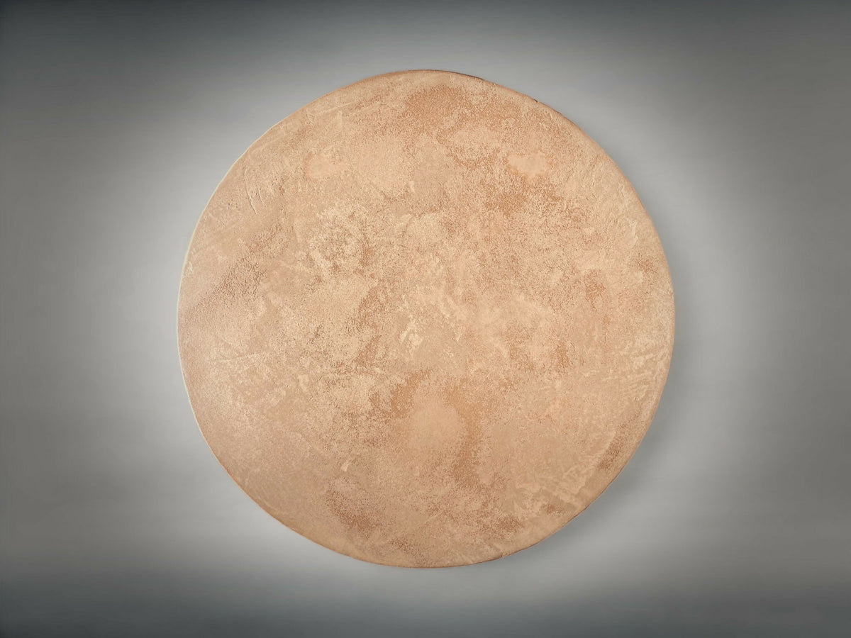 Bout de canapé rond : vue de dessus en tissu beige, surface texturée.