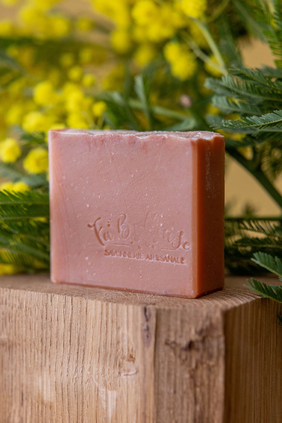 Savon artisanal en barre, rose à l’argile, logo gravé sur le dessus.
