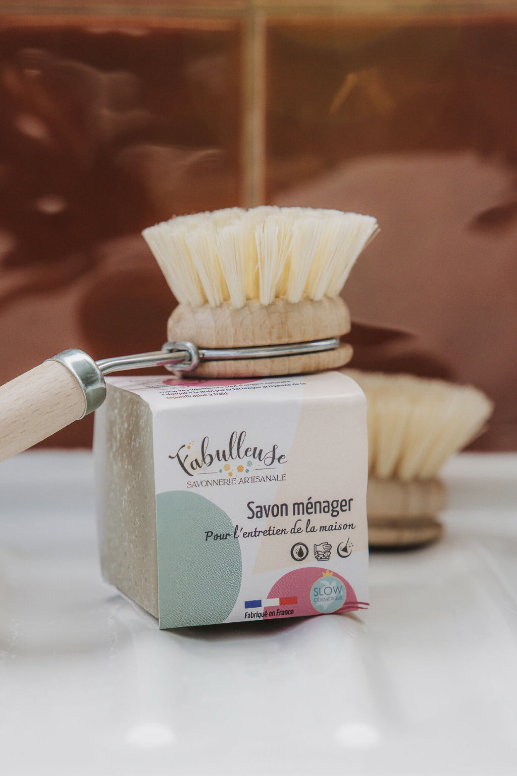 Savon ménager en barre avec brosse à récurer sur le dessus, étiquette blanche