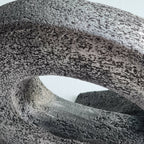 Sculpture en pierre sombre, gros plan de l’ouverture ovale et de la texture