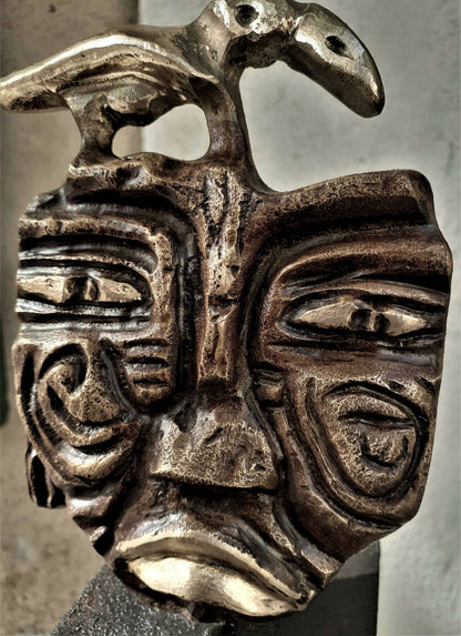 Sculpture bronze oiseau et visage sculpté, gros plan, patine argentée