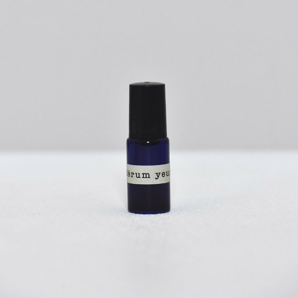 Flacon de sérum pour les yeux avec bouchon noir et base bleu foncé