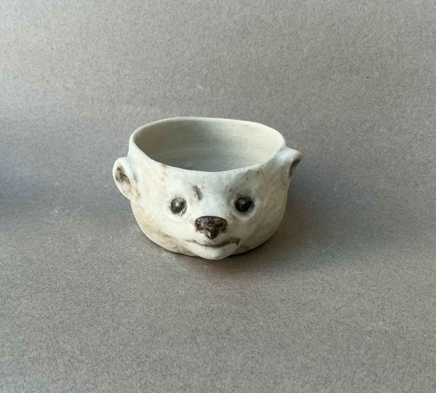 Bol en céramique en forme de visage d’ours, blanc cassé, bords arrondis, motifs noirs