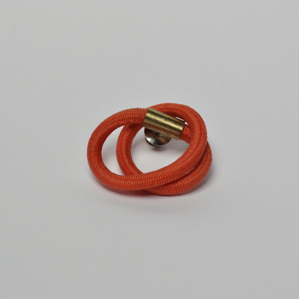 Broche entrelacs cordon orange, fermoir doré avec intérieur visible