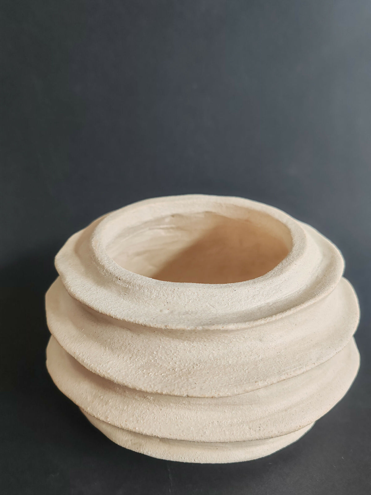 Vase sculptural en céramique blanc cassé, forme en spirale à anneaux superposés