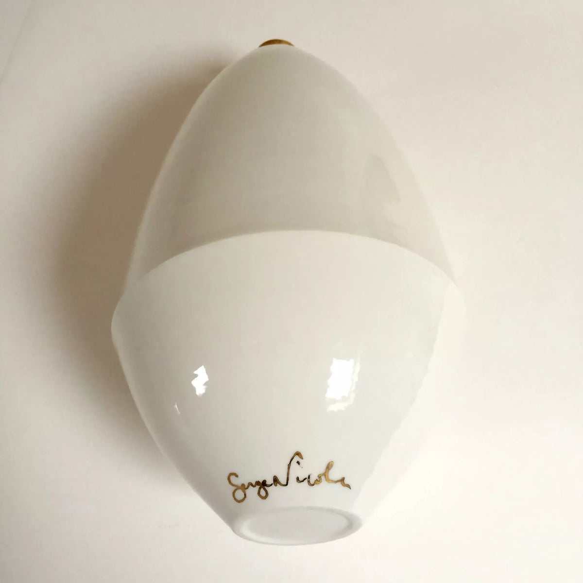 Vase soliflore blanc avec motif visage doré et inscription dorée au fond