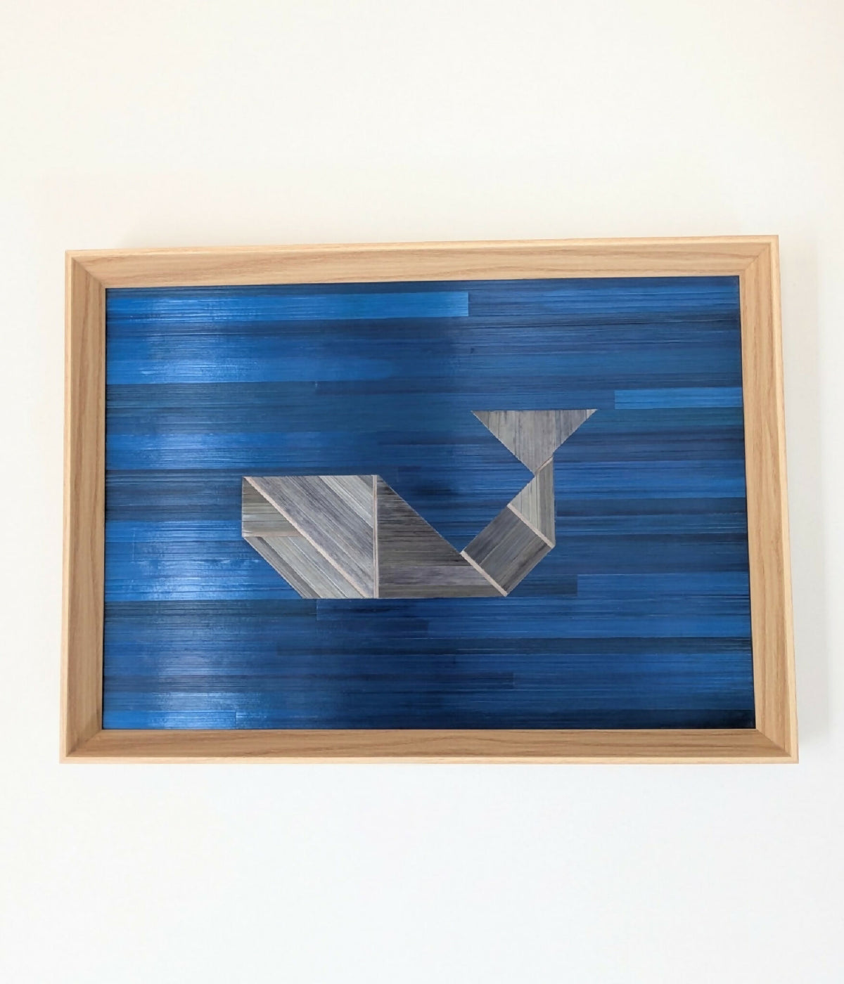 Tableau tangram bleu roi, marqueterie paille grise, cadre bois clair