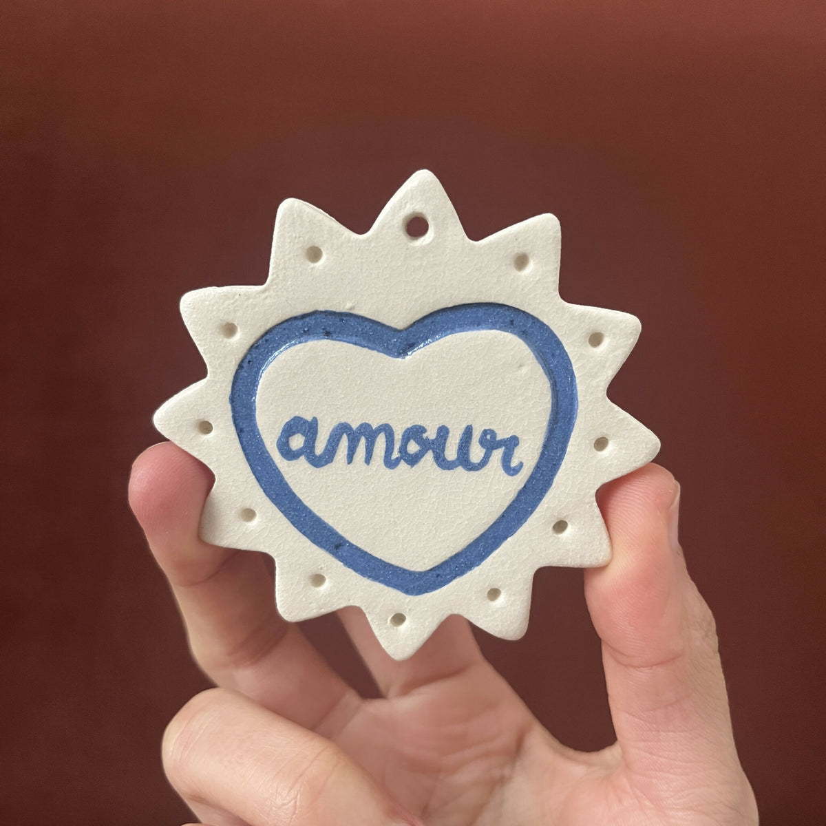 Ex-voto monochrome en étoile, cœur bleu avec le mot « Amor »