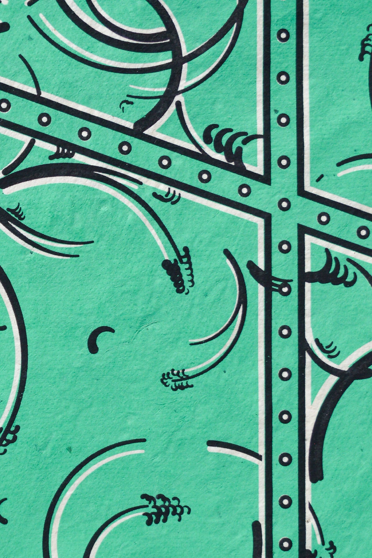 Détail de tissu vert émeraude, arabesques et cadre à picots sur motif géométrique