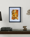 Œuvre abstraite encadrée, touches noires et orange sur fond clair, style gestuel.